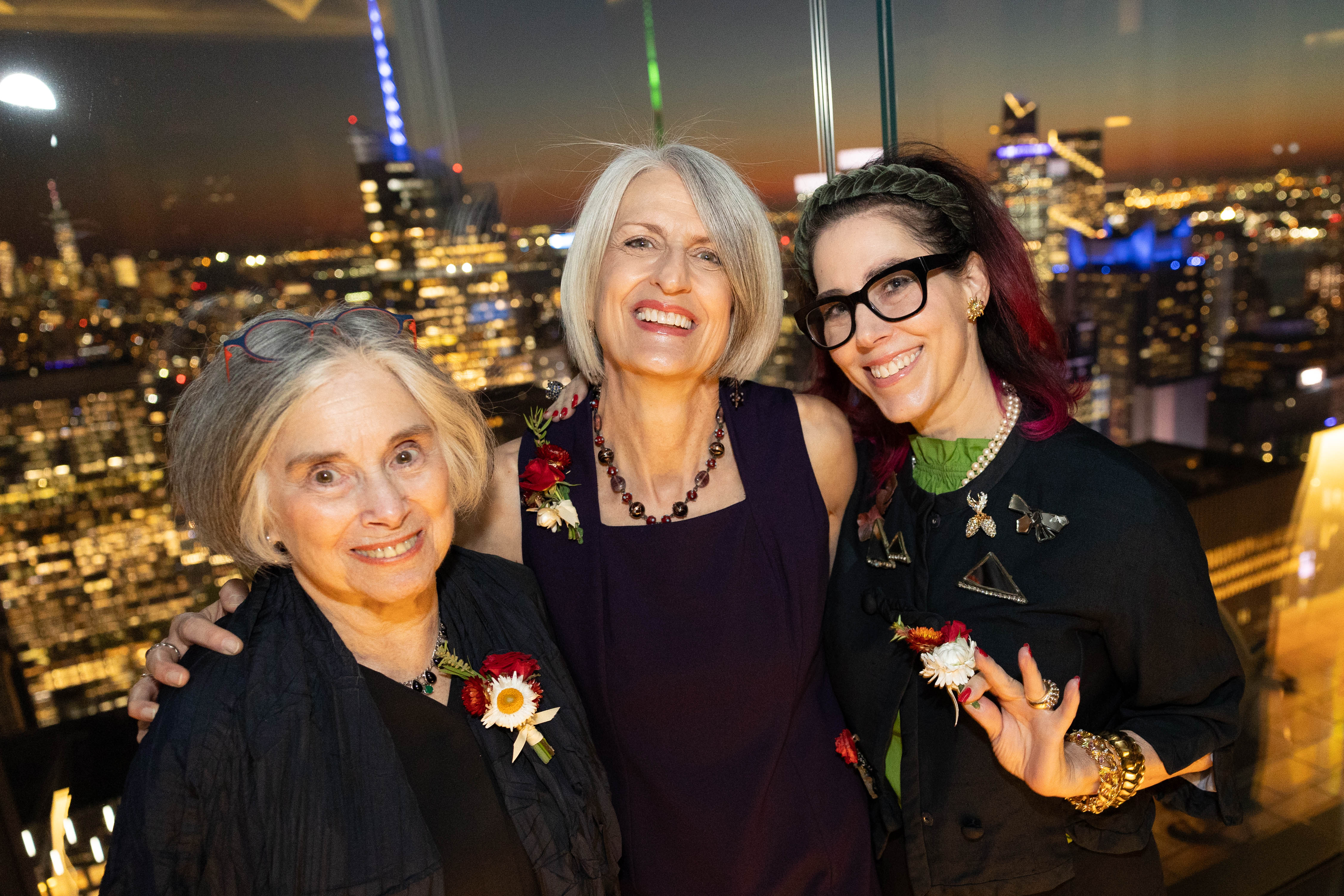 Ruth Fine, Anne Helmreich, and Amanda Quinn Olivar pose for a photograph during cocktail hour.